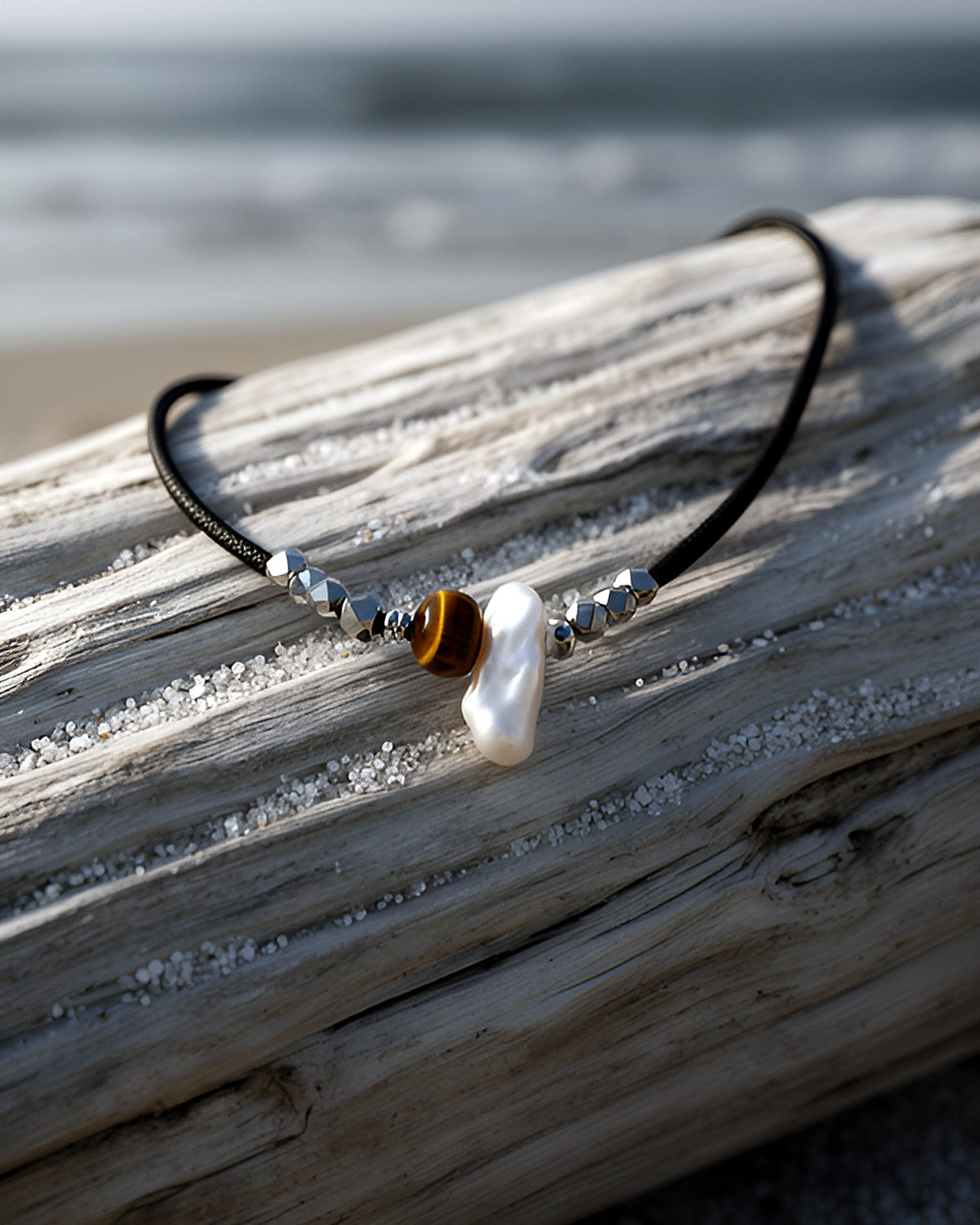 NK-01 tiger's eye + baroque pearl choker — on driftwood