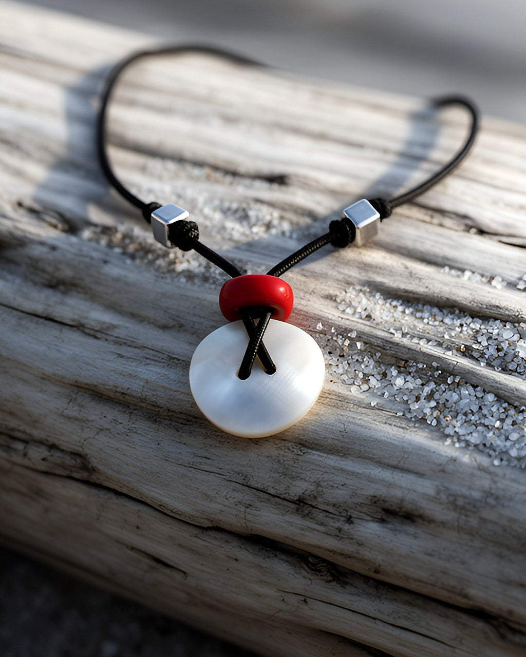 NK-05 mother-of-pearl disc pendant — on driftwood