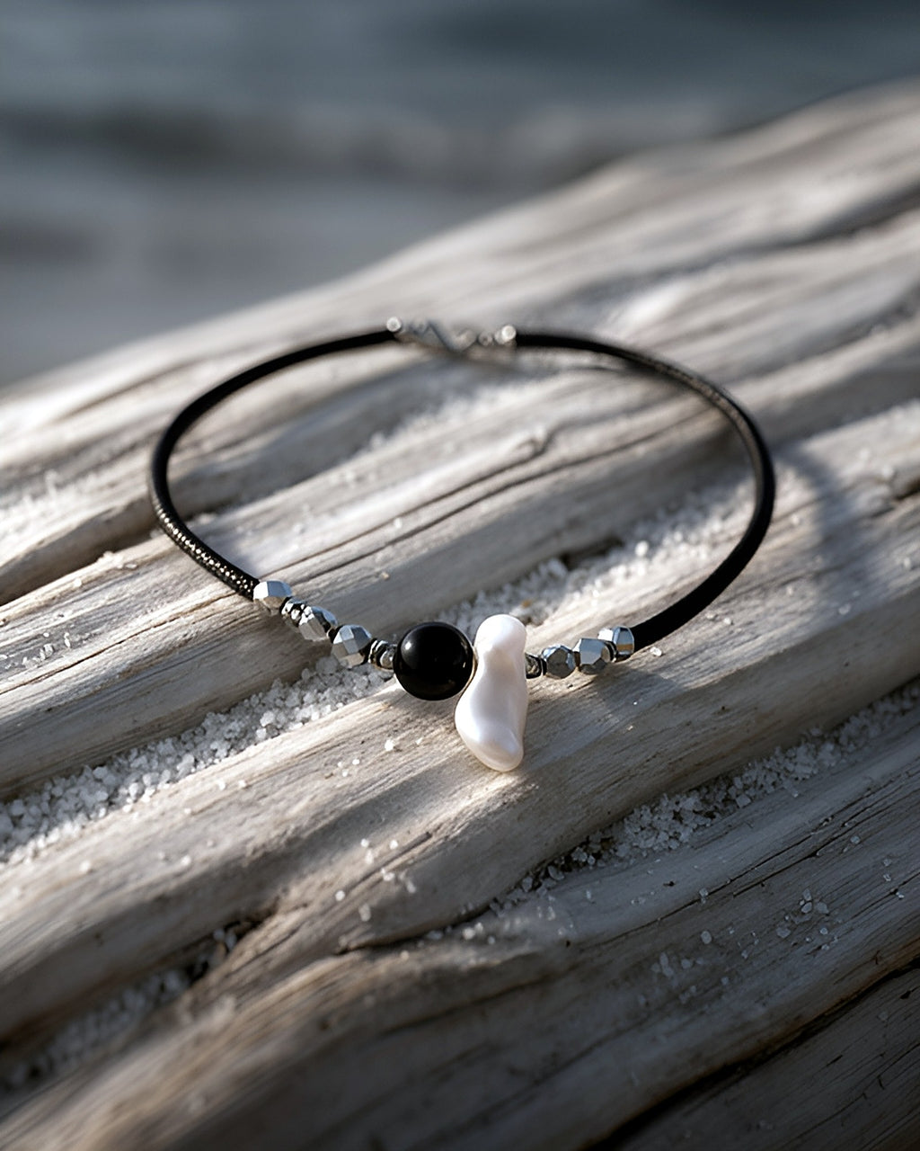 NK-07 onyx + baroque pearl choker — on driftwood