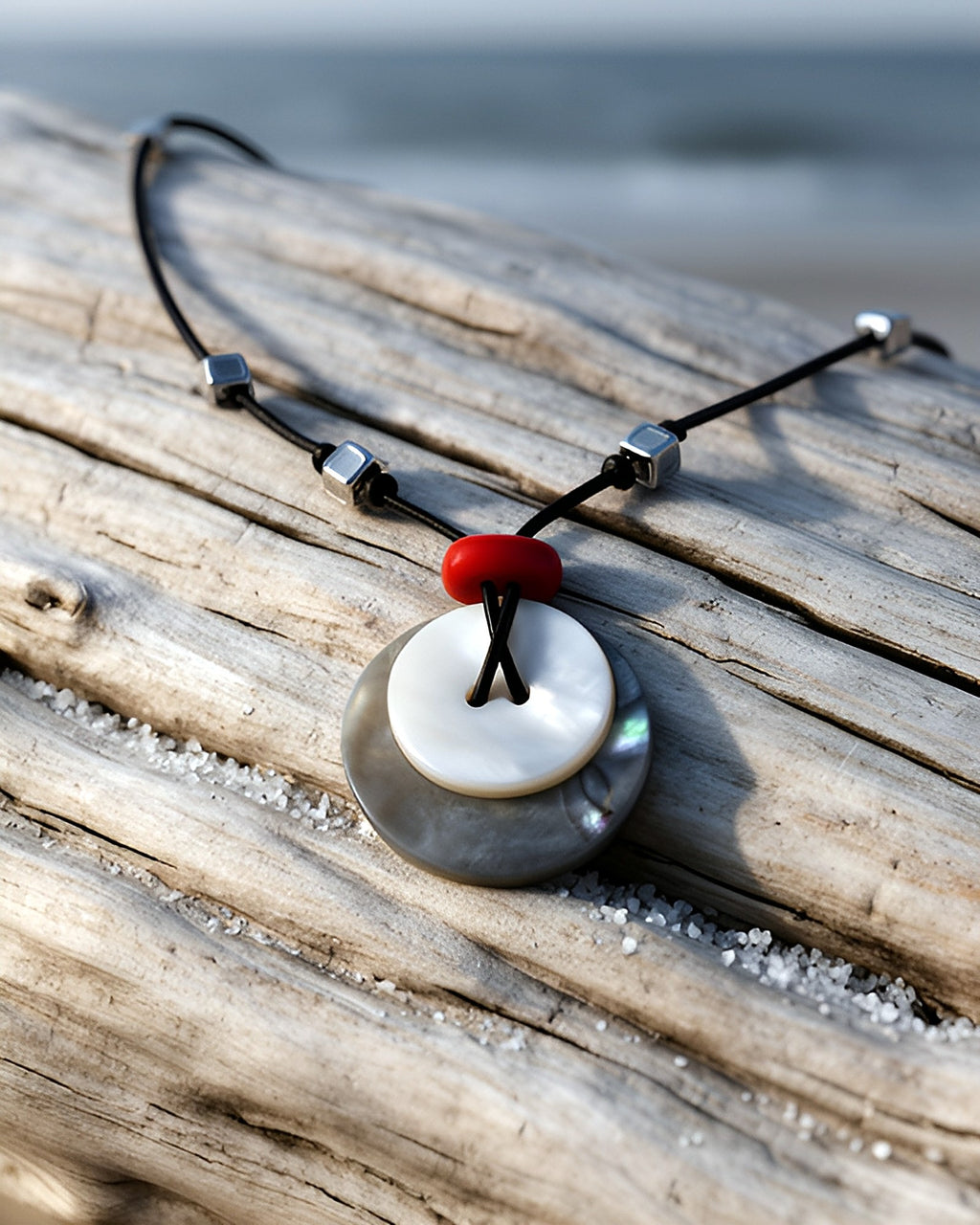 NK-10 tide pair: stacked shell discs — on driftwood